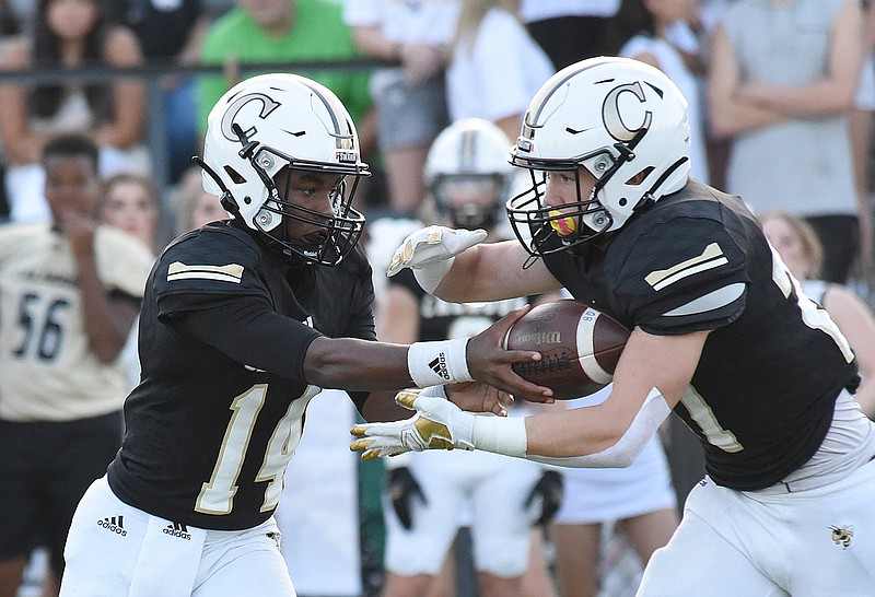 Staff photo by Matt Hamilton / Calhoun's Christian Lewis, left, hands off to Caden Williams during a home game against McCallie on Aug. 27. The Yellow Jackets beat Cass on Friday night.