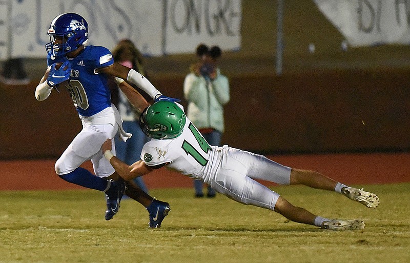 Staff photo by Matt Hamilton / Red Bank's AD Crutcher carries the ball as East Hamilton's Zane Liffick attempts a tackle during Friday night's Region 3-4A showdown.