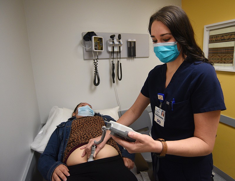 Staff Photo by Matt Hamilton / Dr. Callie Pittard uses a doppler fetal monitor to check the fetal heart rate for Maricruz Ayala Ambriz at Clinica Medicos on Wednesday, October 13, 2021. 