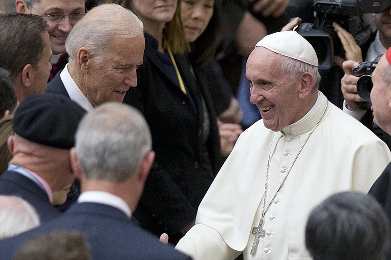 FILE - In this April 29, 2016, file photo Pope Francis shakes hands with Vice President Joe Biden as he takes part in a congress on the progress of regenerative medicine and its cultural impact, being held in the Pope Paul VI hall at the Vatican. (AP Photo/Andrew Medichini, File)


