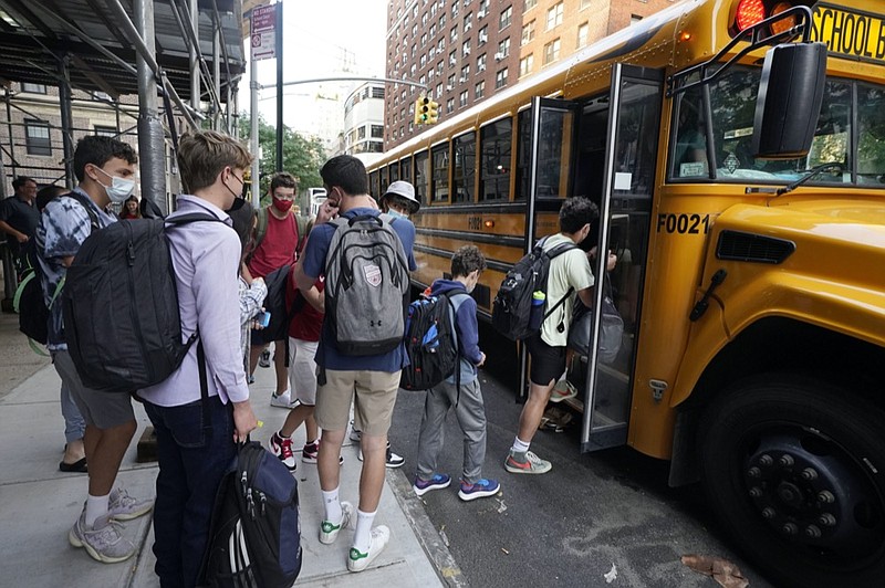 FILE — In this Sept. 13, 2021, file photo, students board a school bus on New York's Upper West Side. (AP Photo/Richard Drew, File)


