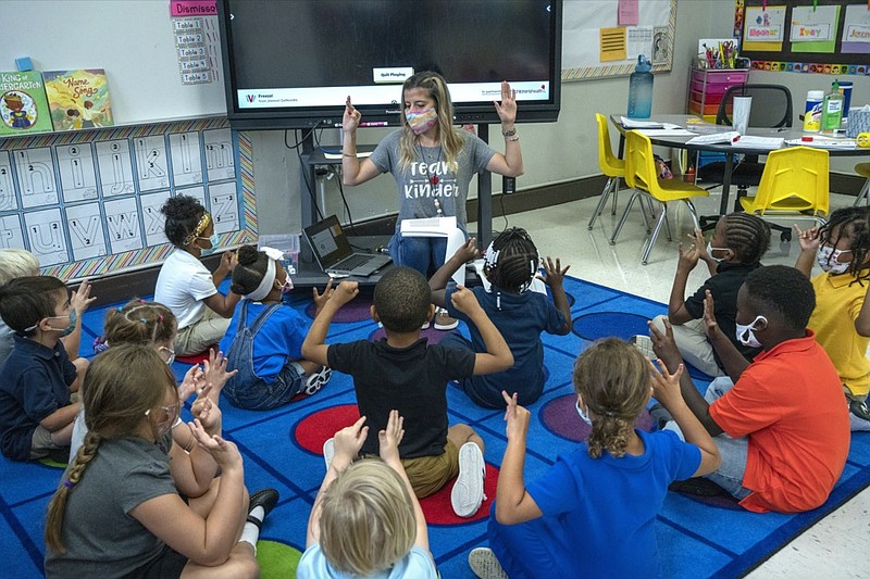 FILE - In this Friday, Aug. 20, 2021, file photo, kindergarten teacher Amber Updegrove interacts with her students at Warner Arts Magnet Elementary in Nashville, Tenn., in Davidson County. (AP Photo/John Partipilo, File)



