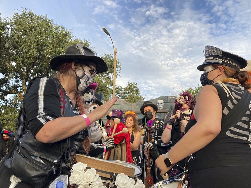 A woman plays a drum ahead of the Krewe of Boo parade on Saturday, Oct. 23, 2021, in New Orleans. (AP Photo/Rebecca Santana)

