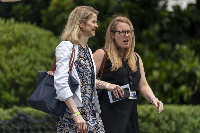 FILE - In this July 13, 2021, file photo Assistant to the President and White House Counsel Dana Remus, left, and Assistant to the President and Deputy Chief of Staff Jen O'Malley Dillon, right, walk toward Marine One on the South Lawn of the White House in Washington to join President Joe Biden for a short trip to Andrews Air Force Base, Md. Remus made a lasting impression on her colleagues with her perpetual calm amid the chaos following last year's election as Donald Trump sought to challenge the very legitimacy of Joe Biden's victory. (AP Photo/Andrew Harnik, File)