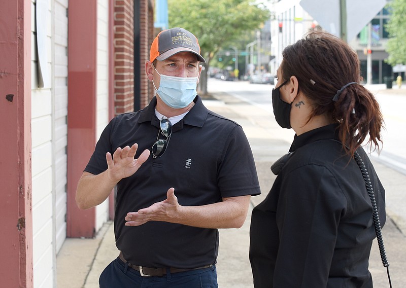 Staff file photo by Matt Hamilton / Downtown Chattanooga Alliance Executive Director Steve Brookes talks with operations manager Randi Haynes about a wall that needs attention in downtown Chattanooga last September.