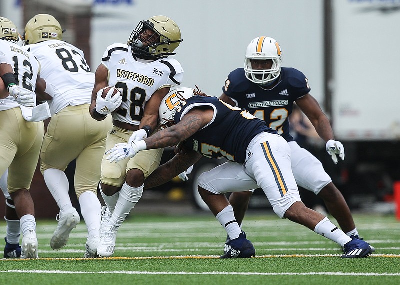 Staff photo by Troy Stolt / Chattanooga Mocs linebacker Kam Jones (57) hits Wofford Terriers running back Ryan Lovelace (28) during the football game between UTC and the Wofford Terriers at Finley Stadium on Saturday, Feb. 27, 2021 in Chattanooga, Tenn.