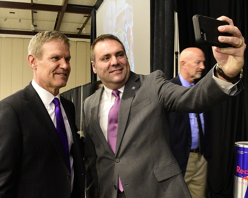 Staff Photo by Robin Rudd / Matt Lea of the Hamilton County Sheriff's Department takes a photo with Governor Bill Lee at the 42nd Annual Chattanooga Area Leadership Prayer Breakfast at the Chattanooga Convention Center on October 26, 2021.