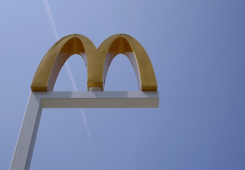 FILE- This Aug. 8, 2018, file photo shows the logo of McDonald's at flagship restaurant in Chicago. McDonald's workers in 12 U.S. cities walked off the job Tuesday, Oct. 26, 2021 to protest what they say is a continuing problem of sexual harassment and violence in the company's stores. Organizers from the labor group Fight for $15 say several hundred workers were expected to participate in Chicago, Miami and other cities. (AP Photo/Nam Y. Huh, File)