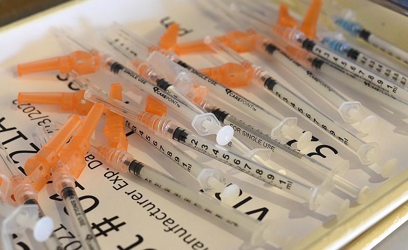 Staff Photo by Matt Hamilton / Syringes sit on a tray before being filled with Moderna vaccine Tuesday, October 26, 2021 at the CARTA bus barn vaccination center.