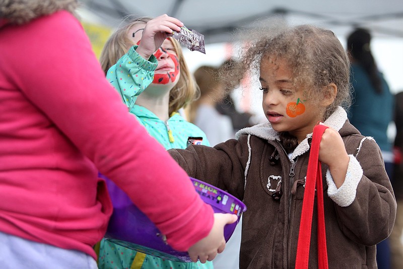 Staff photo by Erin O. Smith / Inger Bland, 4, and Charlie Readus, 4, trick-or-treat at the Ooltewah Farmers Market at the Ooltewah Nursery Thursday, October 31, 2019 in Ooltewah, Tennessee. 