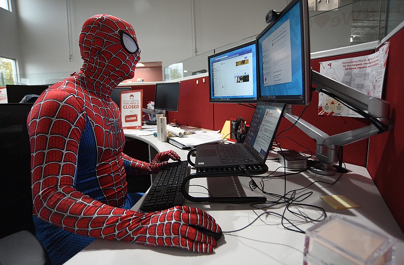 Staff Photo by Matt Hamilton / Training supervisor Nick Stoyer oversees a training exercise at the HomeServe Chattanooga Contact Center on Friday, Oct. 29, 2021. HomeServe, which held a Halloween costume party on Friday, is seeking to fill up to 150 more jobs by January.