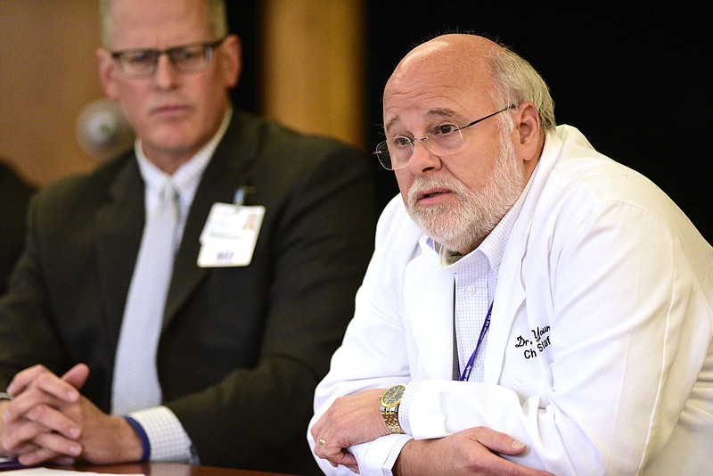 Staff file photo by Robin Rudd / Former Erlanger Chief of Staff Dr. Chris Young praises the medical staff's performance at a hospital board meeting on June 24, 2021, while CEO Dr. Will Jackson, left, listens. The board voted Thursday to remove Young from his leadership role.