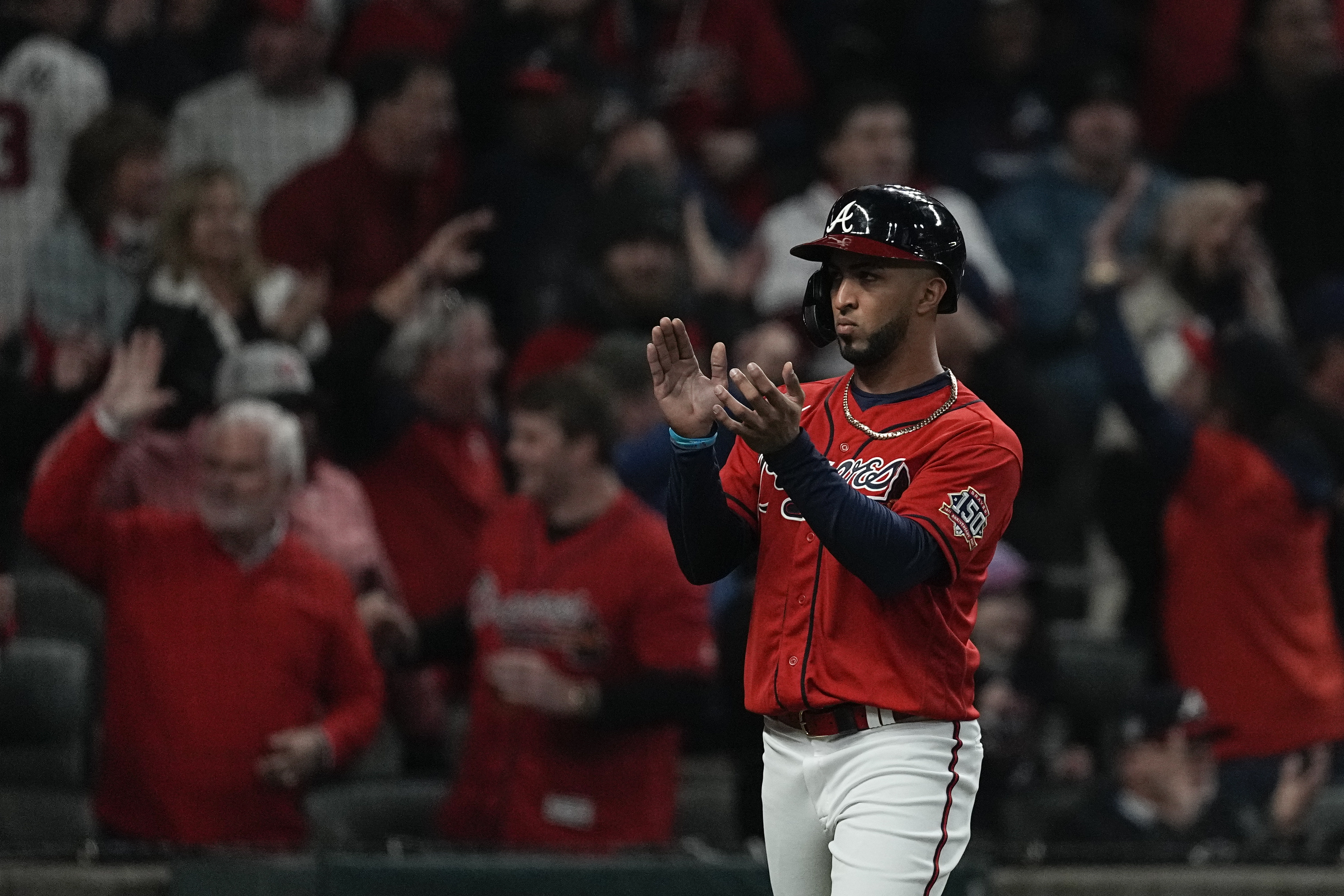 Atlanta Braves' Eddie Rosario applauds after scoring out a double by Austin Riley during the third inning in Game 3 of baseball's World Series between the Houston Astros and the Atlanta Braves Friday, Oct. 29, 2021, in Atlanta. (AP Photo/Brynn Anderson)