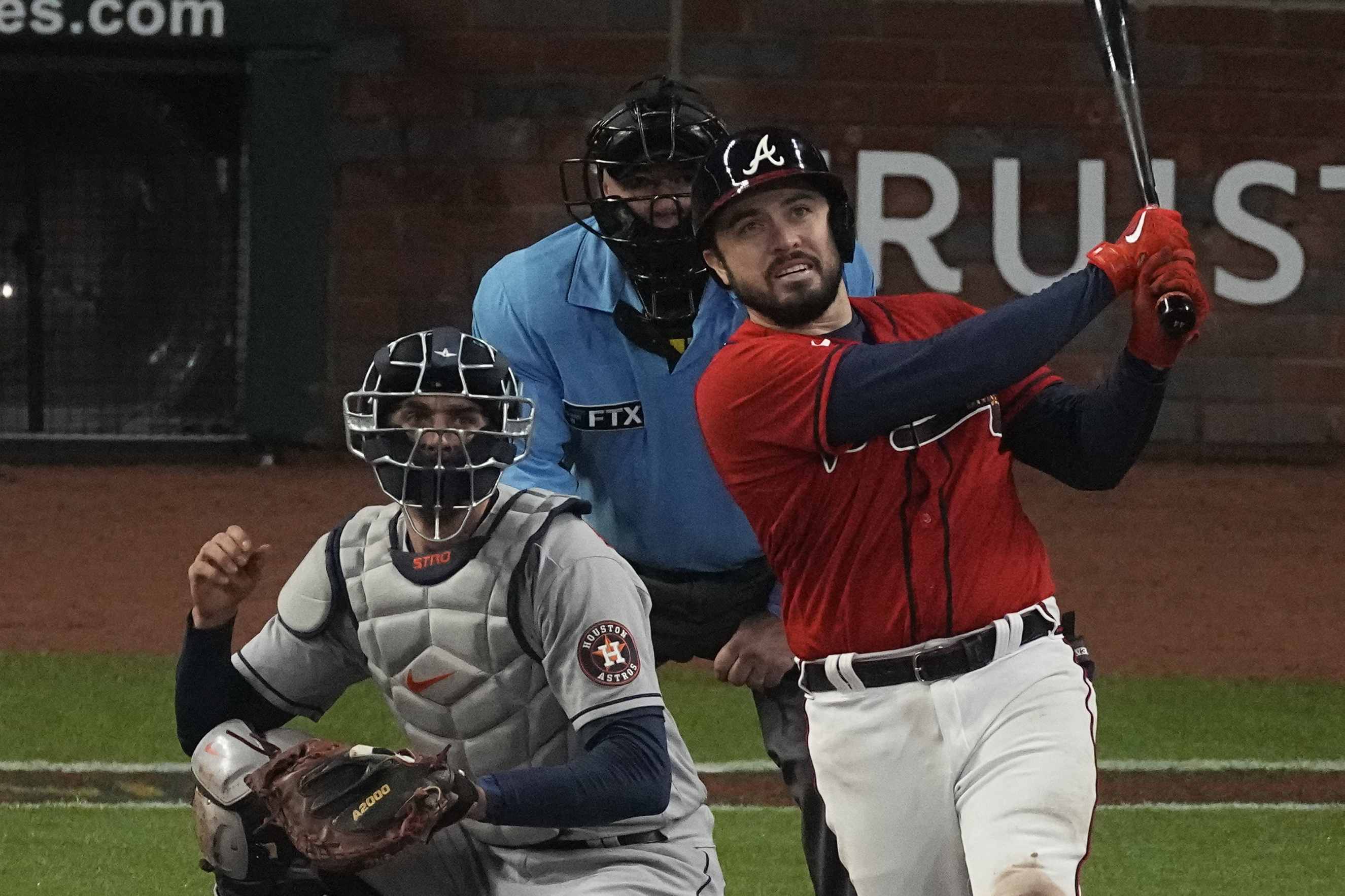 Atlanta Braves' Travis d'Arnaud watches his home run during the eighth inning in Game 3 of baseball's World Series between the Houston Astros and the Atlanta Braves Friday, Oct. 29, 2021, in Atlanta. (AP Photo/John Bazemore)