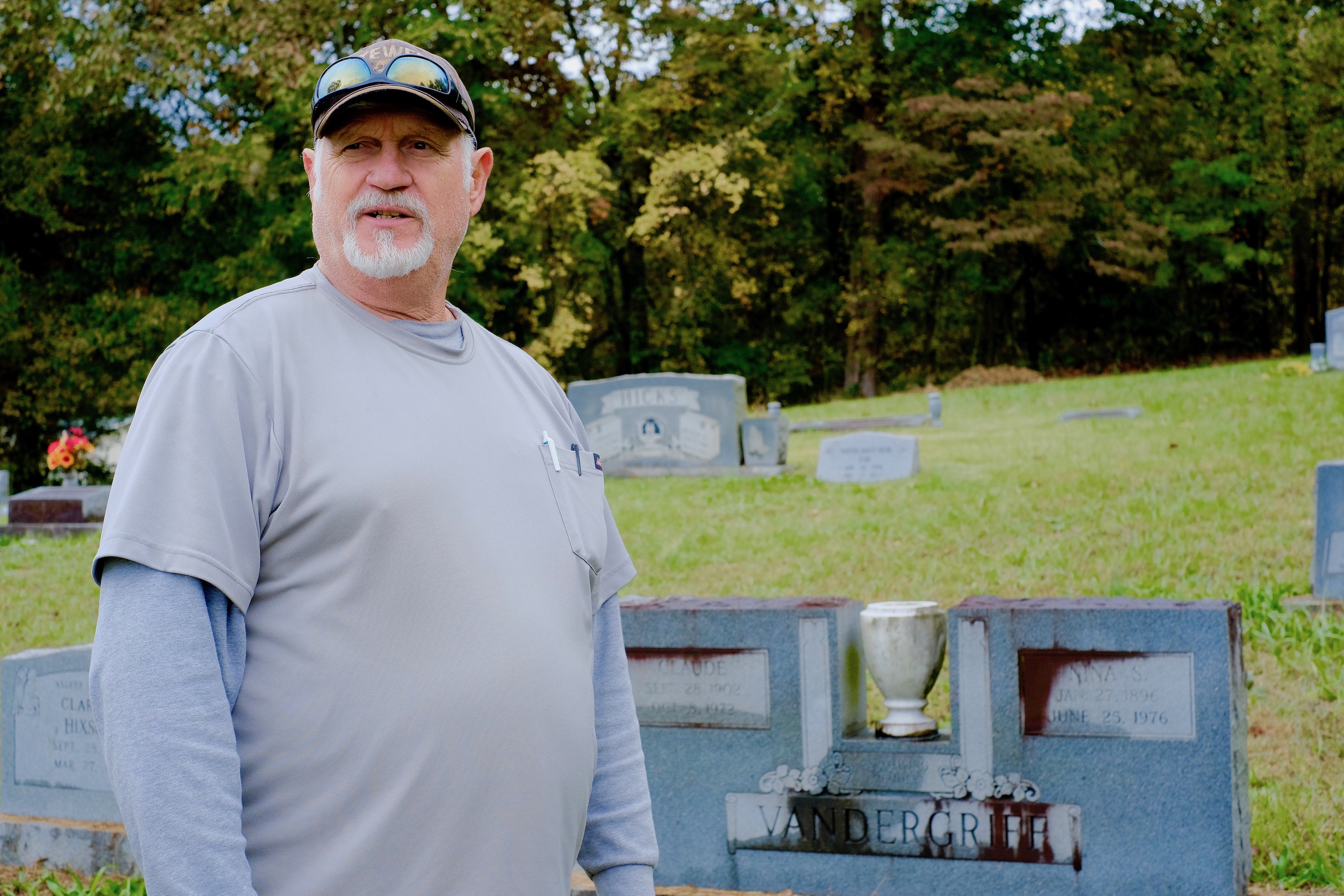 Staff photo by Wyatt Massey / Dennis Harvey stands in the Friendship Baptist Church cemetery in Hixson on Oct. 29, 2021. Harvey's grandparents, whose tombstone is behind him, donated the land to create the cemetery in 1957.