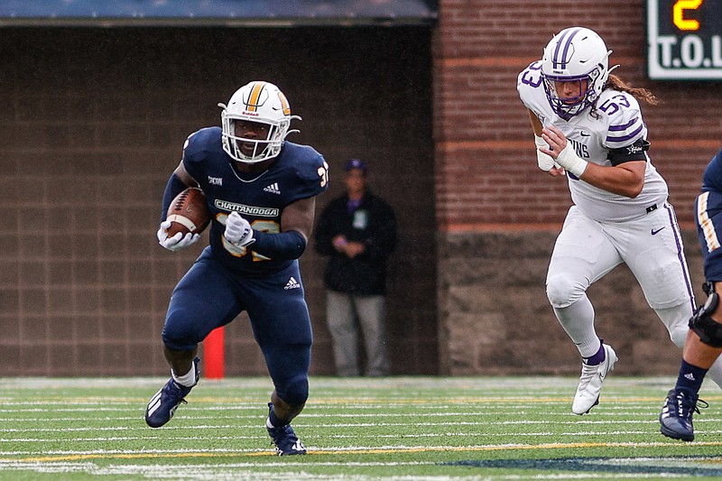 Staff photo by Troy Stolt / UTC's Ailym Ford runs the ball during Saturday's home game against Furman. Ford scored the Mocs' lone touchdown in a 13-3 victory that helped them remain atop the SoCon standings.