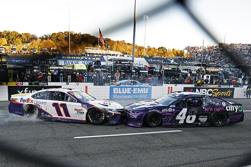 AP photo by Wade Payne / Joe Gibbs Racing driver Denny Hamlin (11) prevents Hendrick Motorsports driver Alex Bowman (48) from doing a celebratory burnout after Bowman won Sunday's NASCAR Cup Series race at Virginia's Martinsville Speedway. Bowman spun Hamlin late in the race to take the lead.