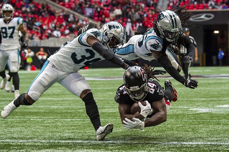 AP photo by Danny Karnik / Atlanta Falcons running back Cordarrelle Patterson, bottom, dives into the end zone for a touchdown as Carolina Panthers safety Sean Chandler, left, and cornerback Donte Jackson are too late to stop him during Sunday's game in Atlanta.