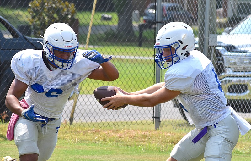 Staff Photo by Patrick MacCoon / Trion senior running back Rob Brown takes a handoff from quarterback Logan Eller at a preseason football practice on Tuesday, August 3, 2021.