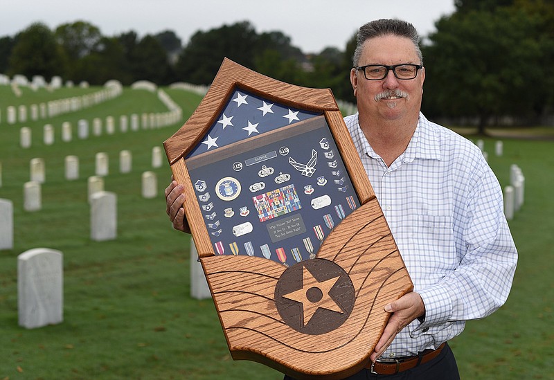 Staff Photo by Matt Hamilton / Air Force veteran Bill Sachse displays a shadowbox featuring memorabilia and medals from his days of service while taking a break from his job working at the Chattanooga National Cemetery on Tuesday, Oct. 12, 2021.