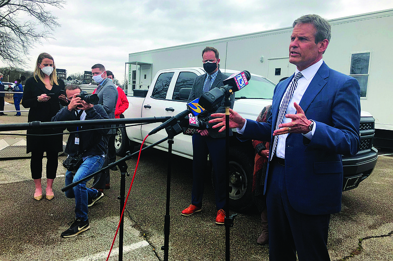 Tennessee Gov. Bill Lee, right, speaks with reporters about vaccine distribution problems in the state's most populous county on Friday, Feb. 26, 2021, in Memphis, Tenn. (AP Photo/Adrian Sainz)