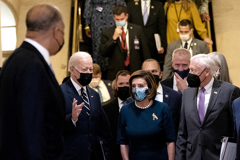 Photo by Stefani Reynolds of The New York Times / President Joe Biden walks with Speaker of the House Nancy Pelosi, D-Calif., and House Majority Leader Steny Hoyer, D-Md., at the Capitol in Washington on Thursday, Oct. 28, 2021.