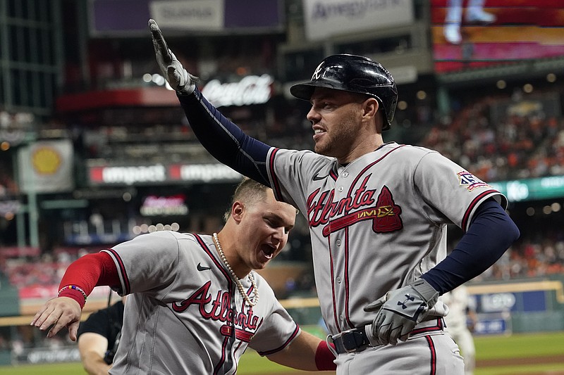 AP photo by Eric Gay / Atlanta Braves first baseman Freddie Freeman, right, celebrates his solo home run with outfielder Joc Pederson during the seventh inning of Game 6 of the World Series against the host Houston Astros on Tuesday night. Freeman's homer supplied the final run of the game and he also recorded the final out as the Braves won 7-0 to wrap up the title.