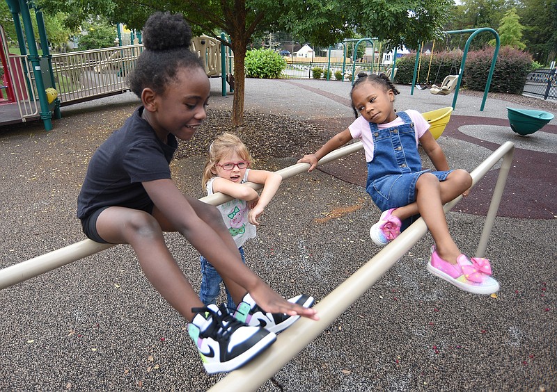 Staff Photo by Matt Hamilton / From left, Ja'zelle Jenkins, Elizabeth Hall and Ryley Boston play on the playground on Thursday, Sept. 16, 2021, at Signal Centers. Friends of Special Children is holding a fundraiser for playground equipment for Signal Centers.