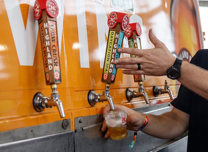 Staff file photo by Doug Strickland / A vendor pours a beer at the at First Tennessee Pavilion in Chattanooga in this 2019 file photo. Vendors can now apply for a one-time permit to sell beer at events in Red Bank city properties under the city's new beer ordinance passed Monday night.