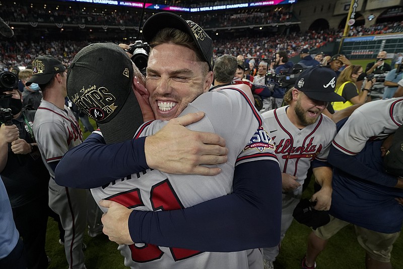 AP photo by Eric Gay / Atlanta Braves first baseman Freddie Freeman, right, hugs relief pitcher Will Smith after the team's 7-0 win in Game 6 of the World Series on Tuesday night in Houston. Freeman had an RBI double and a solo homer to help the Braves blow out the Astros and wrap up the title in six games.