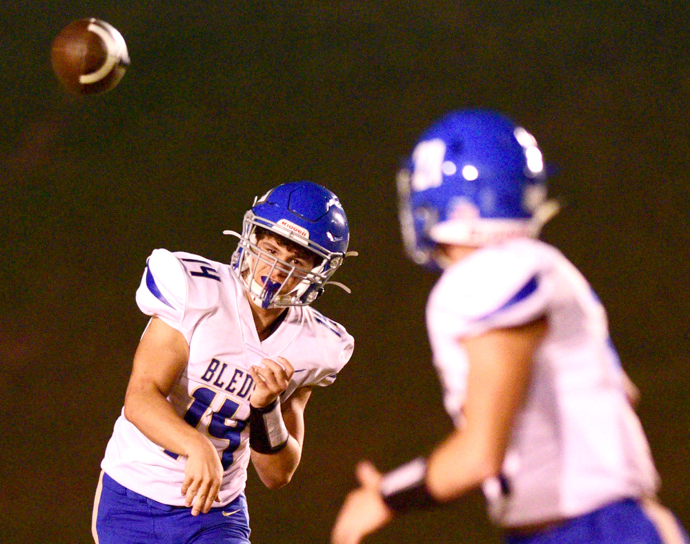 Staff file photo by Robin Rudd / Bledsoe County quarterback Jonathon Thomas, left, throws a pass to Sam Agee. Bledsoe County (5-3) will travel to Watertown (7-3) for the first round of the Class 2A playoffs on Friday.