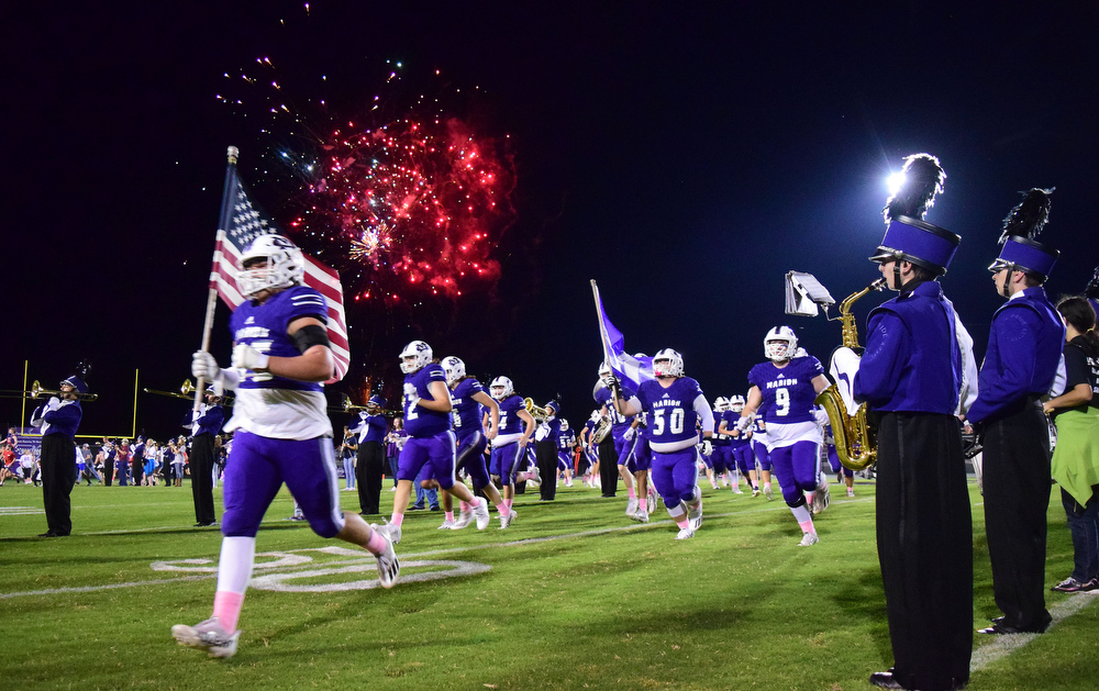 Staff file photo by Robin Rudd / Fireworks burst overhead as Marion County's football team takes the field. The Warriors (8-1) will host Westmoreland (3-7) for the first round of the Class 2A playoffs on Friday.