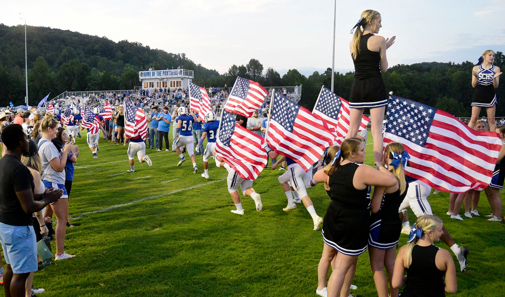 Staff file photo by Robin Rudd / Sale Creek football players carry U.S. flags as they take the field for the first time at the Tobin Davidson Stadium and Sports Complex. The Panthers (5-5) head to Clay County (9-1) for the first round of the Class 1A playoffs on Friday.