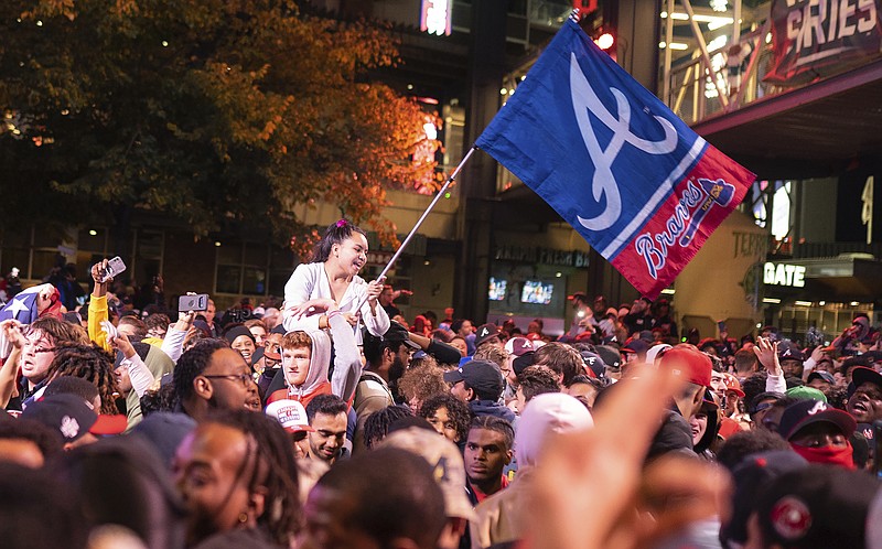 AP photo by Rita Harper / Atlanta Braves fans celebrate near Truist Park on Tuesday night after the team wrapped up its first World Series title since 1995 by beating the Houston Astros on the road.