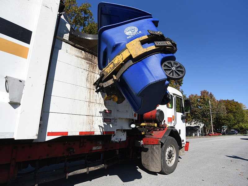 Staff Photo by Matt Hamilton / Shane Scott drives a city of Chattanooga recycling truck as he picks up items along Ashley Forest Drive earlier this week.