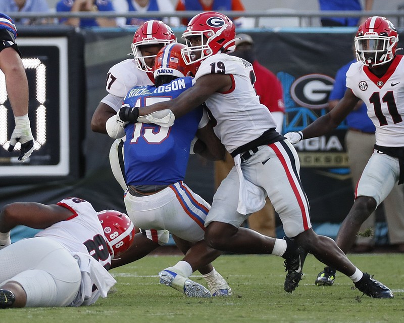 Atlanta Journal-Constitution photo by Bob Andres via AP / Florida quarterback Anthony Richardson is tackled by Georgia linebackers Adam Anderson (19) and Nakobe Dean during the second half of this past Saturday's game in Jacksonville.