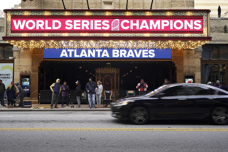 People await a victory parade outside the Fox Theatre, Friday, Nov. 5, 2021, in Atlanta. The Braves beat the Houston Astros 7-0 in Game 6 on Tuesday to win their first World Series baseball title in 26 years. (AP Photo/Brynn Anderson)