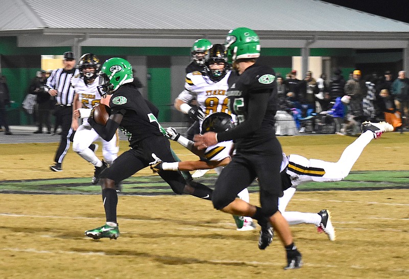 Staff photo by Patrick MacCoon / East Hamilton punt returner Brian Bradshaw breaks away from a DeKalb County player for a big gain in the first half of Friday's home playoff game for Bradshaw and the Hurricanes.