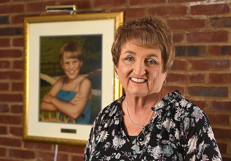 Staff Photo by Matt Hamilton / Jane Kaylor is photographed in front of the portrait of her daughter, Lori, at the Ronald McDonald House on Wednesday, Nov. 3, 2021. Lori died at age 9 from leukemia.