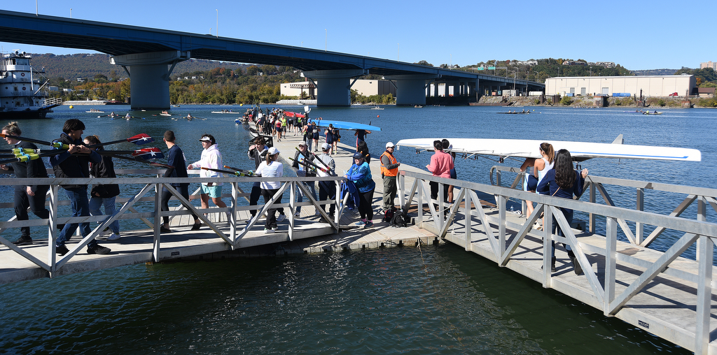 Staff Photo by Matt Hamilton / Teams carry their boats and oars to the launching point on Sunday November 7, 2021 during the Head of the Hooch regatta.