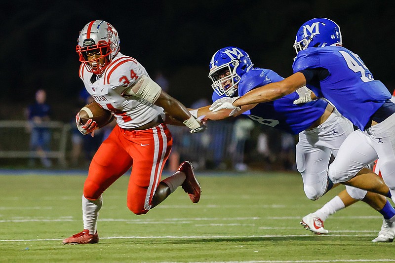 Staff photo by Troy Stolt / Baylor's Caleb Hampton (34) runs the ball during the football game between McCallie School and Baylor on Friday, Oct. 1, 2021 in Chattanooga, Tenn.
