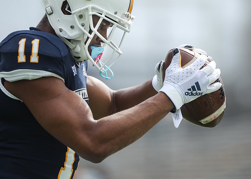 Staff photo by Troy Stolt / Chattanooga Mocs wide receiver Tyron Arnett (11) makes a catch before the start of the football game between UTC and the Wofford Terriers at Finley Stadium on Saturday, Feb. 27, 2021 in Chattanooga, Tenn.