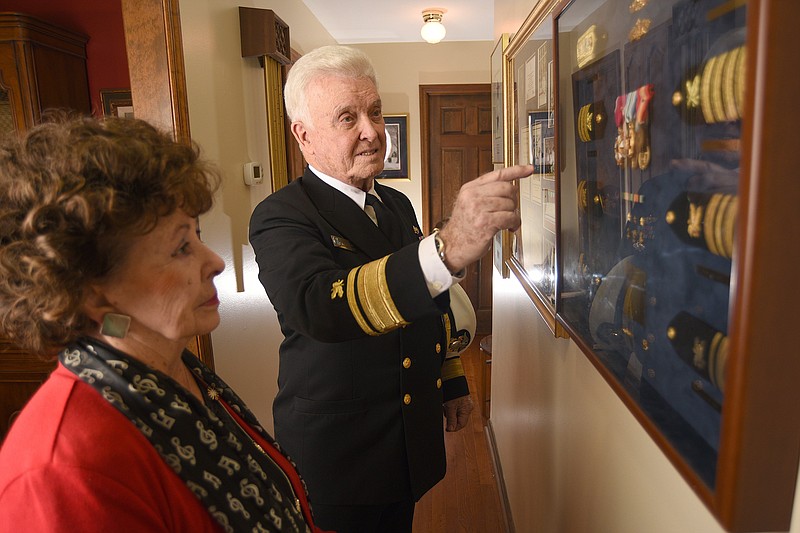 Staff Photo by Matt Hamilton / Vance Fry looks at his collection of shoulder insignia with his wife Charlynne at their home in Harrison on Tuesday, November 2, 2021. 
