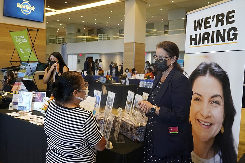 FILE - Marriott human resources recruiter Mariela Cuevas, left, talks to Lisbet Oliveros, during a job fair at Hard Rock Stadium, Friday, Sept. 3, 2021, in Miami Gardens, Fla. The number of Americans applying for unemployment benefits fell to a new pandemic low 267,000 last week, another sign that the job market is recovering from last year's sharp coronavirus downturn. Jobless claims fell by 4,000 last week, the Labor Department reported Wednesday, Nov. 10. (AP Photo/Marta Lavandier, File)