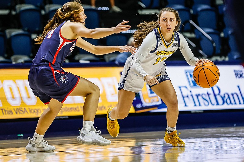 Staff photo by Troy Stolt / UTC point guard Dena Jarrells drives to the basket against Belmont on Tuesday night at McKenzie Arena.