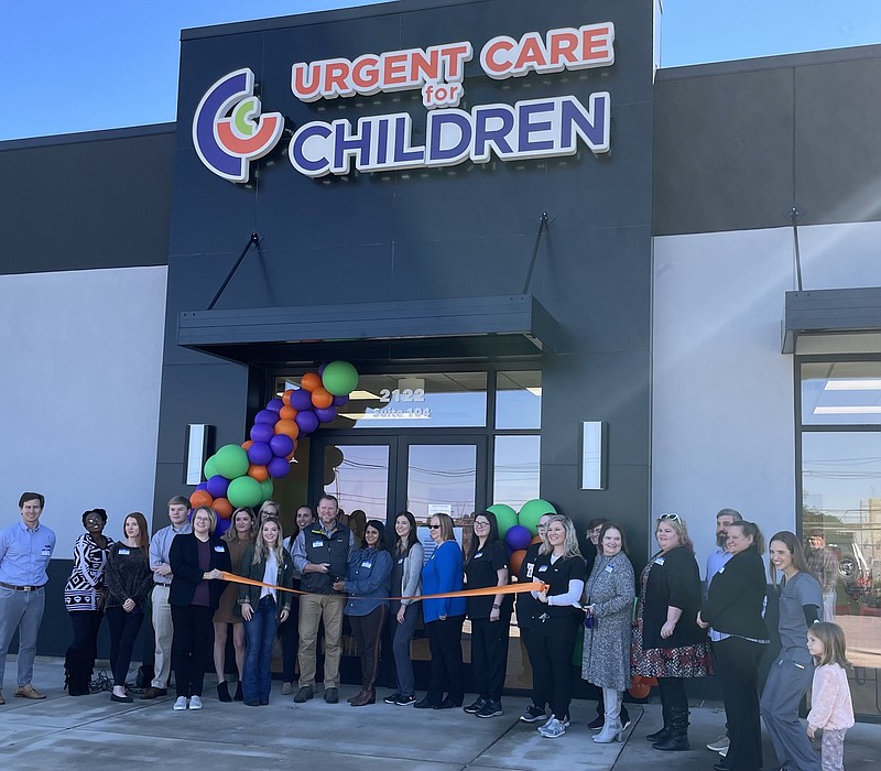 Photo by Dave Flessner / The Chatanooga Area Chamber of Commerce and staff of the Urgent Care for Children prepare to cut the ribbon Friday to open the company's newest clinic on Gunbarrel Road.