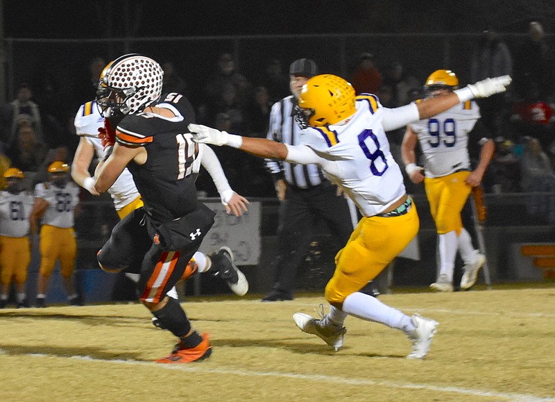 Staff photo by Patrick MacCoon / Meigs County senior receiver Cameron Huckabey breaks free from a Trousdale County defender for a 39-yard gain in the first half of Friday's Class 2A second-round playoff game at Jewell Field in Decatur, Tenn.
