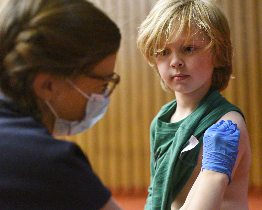 Staff Photo by Matt Hamilton / Nurse practitioner Meghan Whitehead prepares the arm of Lookout Mountain resident Kizer Burbank, 7, before giving him a COVID-19 vaccination shot on Friday, November 13, 2021 at the downtown branch of the Chattanooga Public Library. Lifespring Community Health was providing vaccination shots to children as young as five years old on Friday.