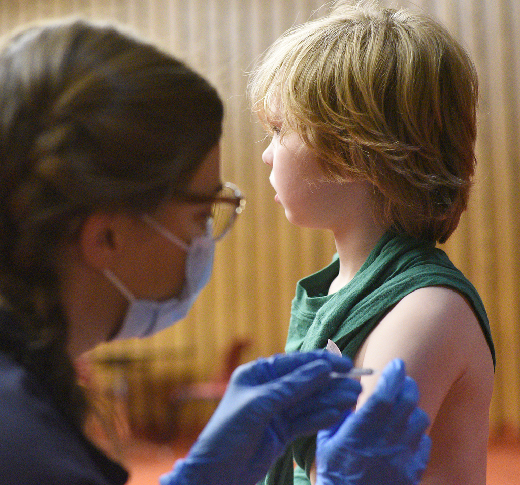 Staff Photo by Matt Hamilton / Nurse practitioner Meghan Whitehead gives a COVID-19 vaccination to Lookout Mountain resident Kizer Burbank, 7, on Friday, November 13, 2021 at the downtown branch of the Chattanooga Public Library. Lifespring Community Health was providing vaccination shots to children as young as five years old on Friday.
