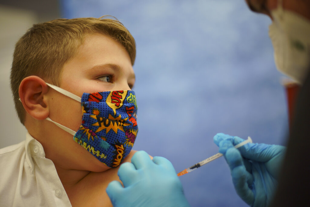 Mikey Farias, 10, receives the Pfizer COVID-19 vaccine for children ages 5-11 at a state-run site in Cranston, R.I., Thursday, Nov. 4, 2021. (AP Photo/David Goldman)